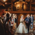 Bride walking down aisle at wedding ceremony.