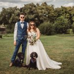 Bride and groom with dogs in a garden