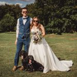 Wedding couple with dogs in sunny park