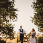 Bride and groom holding hands outdoors