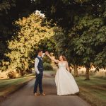 Couple dancing on a tree-lined path