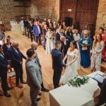 Wedding ceremony in rustic brick venue.