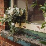 White rose bouquet on rustic windowsill