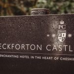 Peckforton Castle sign with crest, Cheshire hotel.