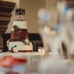 Three-tier wedding cake with decoration and candles.