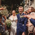 Bride and groom showered with confetti at wedding