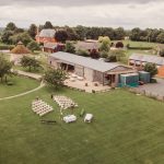 Countryside wedding venue with outdoor seating arrangement.