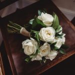 White rose bouquet on wooden chair