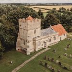 Historic countryside church with graveyard view.