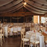 Rustic wedding reception setup with decorated tables.