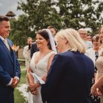 Couple exchanging vows at outdoor wedding ceremony.