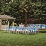 Outdoor wedding setup with chairs and gazebo.