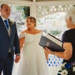 Bride and groom during outdoor wedding ceremony.