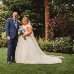 Bride and groom in garden, smiling