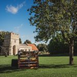 Historic church and wedding notice in scenic landscape.