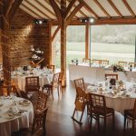 Rustic wedding reception with decorated tables.