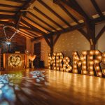 Cosy wedding venue with illuminated Mr & Mrs sign.