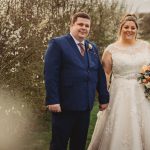 Wedding couple holding hands outdoors