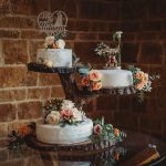 Three-tier wedding cake with floral decoration.