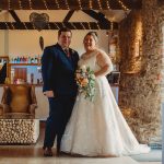 Bride and groom in rustic wedding venue